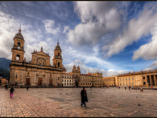 The Plaza de Bolivar is the main square in Bogota, Colombia. I was fortunate to stay close by so I headed out to the plaza in the morning, in the early sun. The church is the main cathedral, Catedral Primada, and the buildng on the right the Congress building.ISO 100, 10mm, f9 (1/400, /1600, 1/400, 1/100) handheld. HDR processed in Photomatix Details Enhancer.  Imagenomics Noiseware. The warm look is the result of the Nik Skylight Filter and Indian Summer filters. Sharpened with Smart Sharpen and Freaky Details.